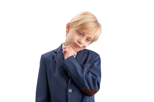 Brooding schoolboy is isolated on white background Boy in school uniform thinks about something