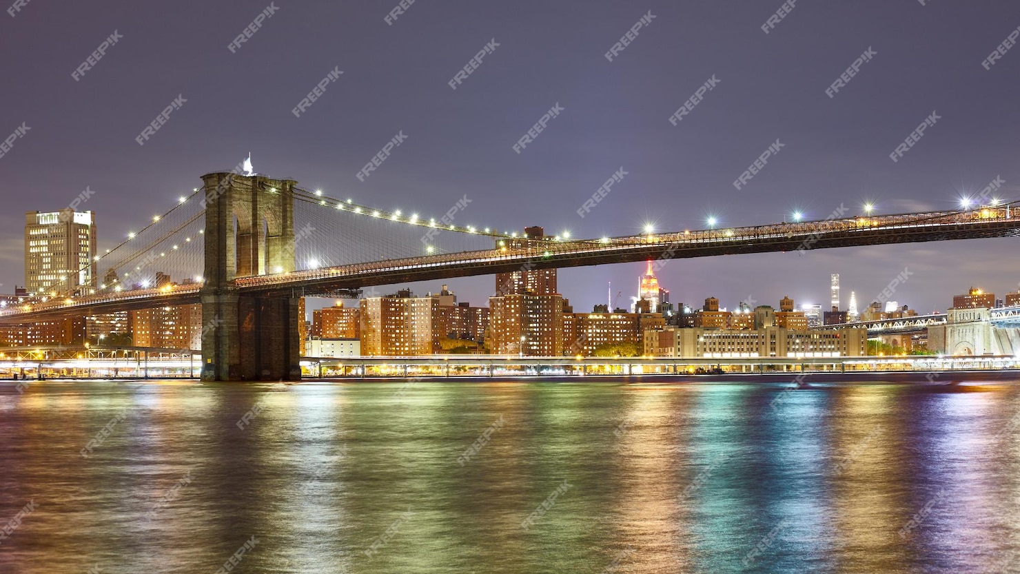 Premium Photo | Brooklyn bridge with city lights reflected in east ...