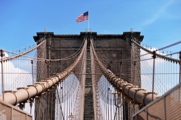 Brooklyn bridge with united states flag on top