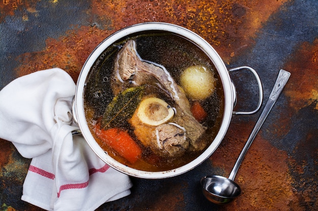 Broth soup in a cooking pot