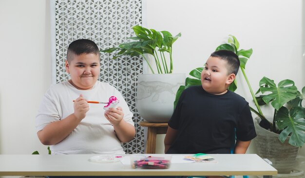 Brother and brother learn and do activities in the home.