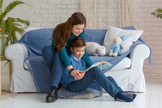 Brother and sister are reading a book.