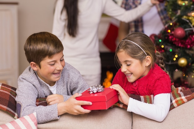 Brother and sister holding a gift 