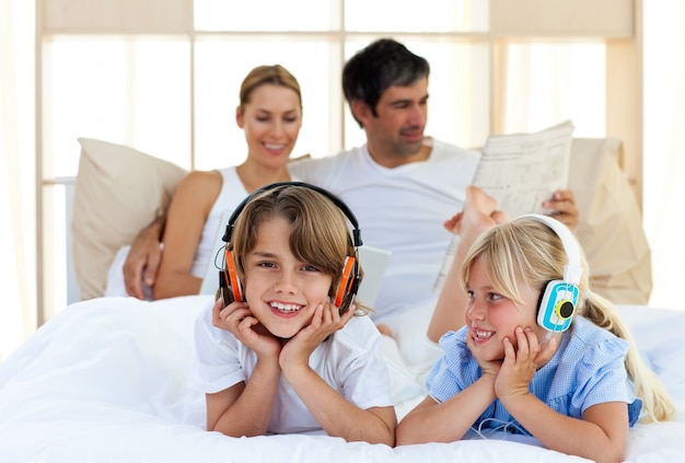 Brother and sister listening music with headphones