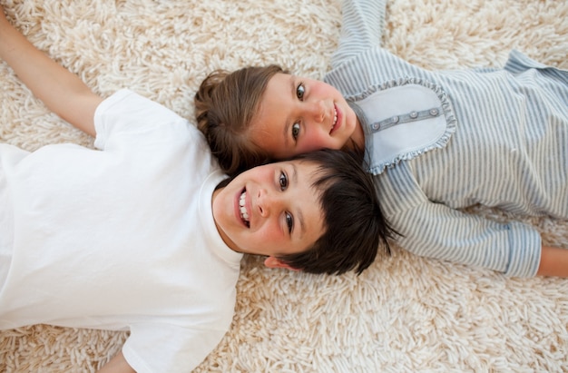 Brother and sister lying on the floor 