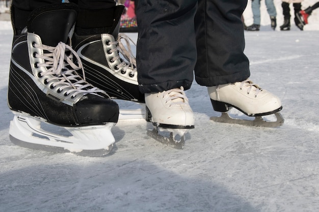 Photo brother and sister skating on frozen pond, place for text