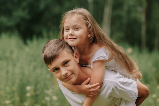 brother and sister in the summer meadow