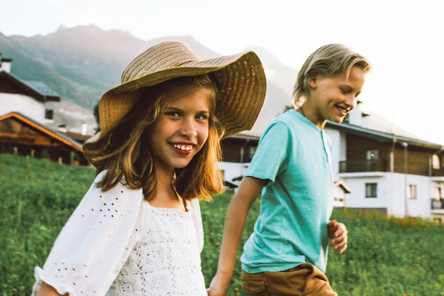 brother and sister walking on the meadow