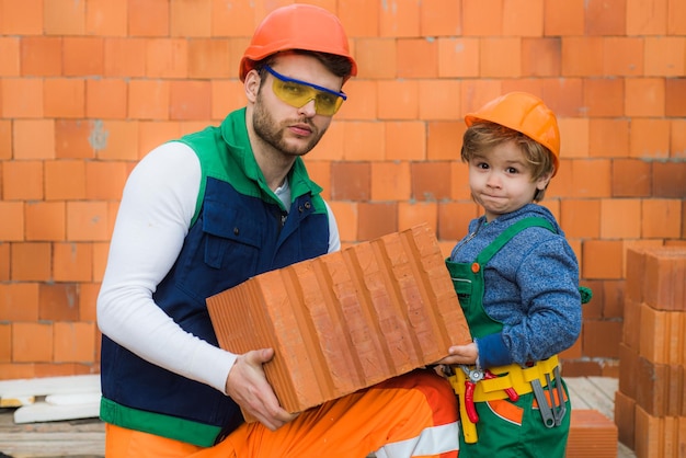 Brothers bricklayers make masonry builders work with brick layer