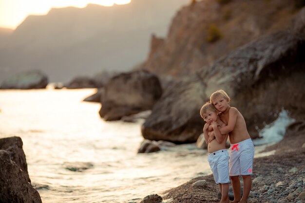 Brothers standing together on a beach