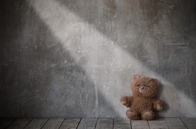 Brouwn teddy bear on old grunge background