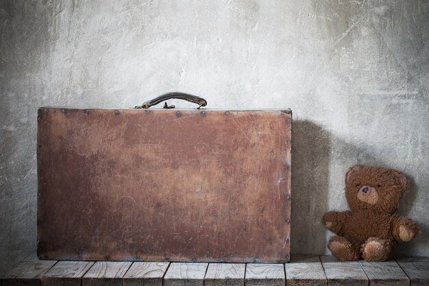 Brouwn teddy bear and old suitcase