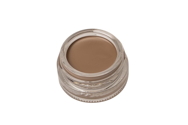 A brow pomade in blonde shade with brush isolated on a white background