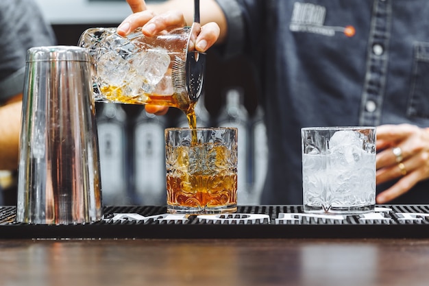 Brown alcoholic cocktail with ice in restaurant high quality photo