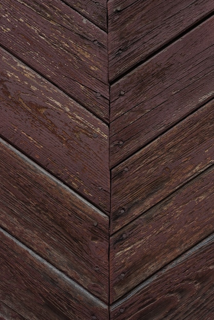 Brown background with aged wood grain texture with peeling paint