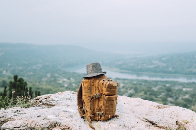 Brown backpack stands on the stones