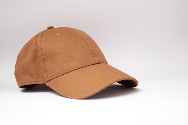 写真 白い背景の上の茶色の野球帽