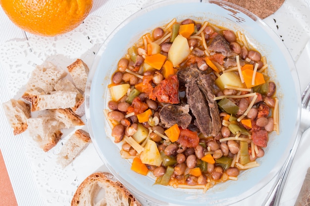 Brown beans with meat and carrot