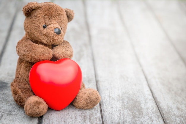 Brown Bear and Red Heart with old wood background for take care your love