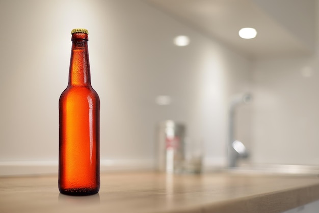 Brown beer bottle on kitchen table Mockup design presentation No label water drops