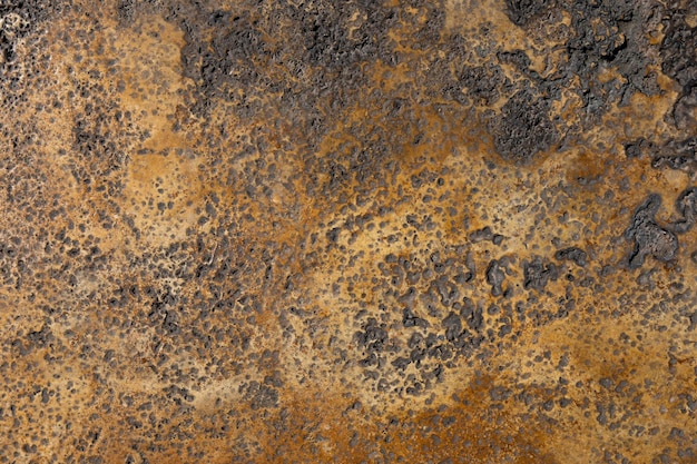 A brown and black surface with a brown surface and black spots.