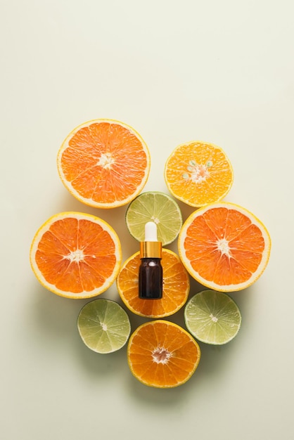 Brown bottle with lemon orange tangerine and vitamin c on white background