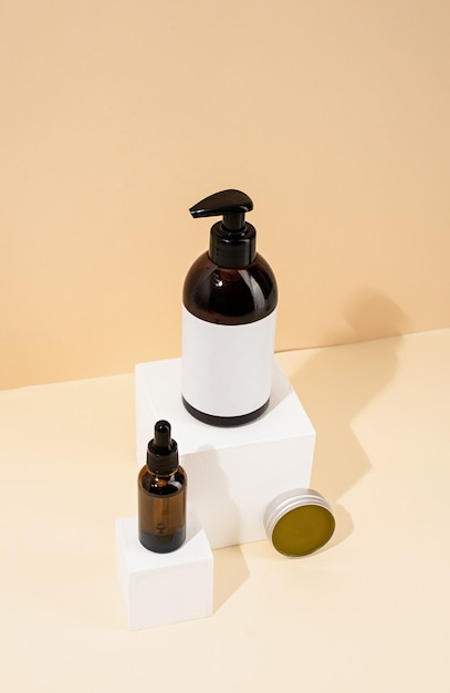 brown bottles mockup for natural skincare cosmetics spa accessories on white podiums cream background