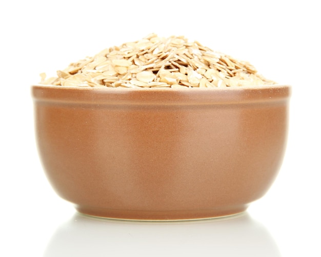 Brown bowl full of oat flakes isolated on white