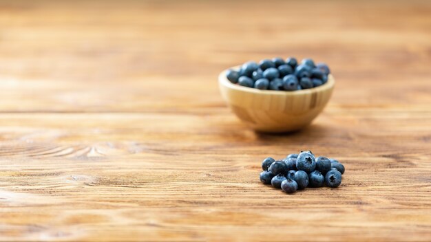 Brown bowl with blueberries on table with copy space