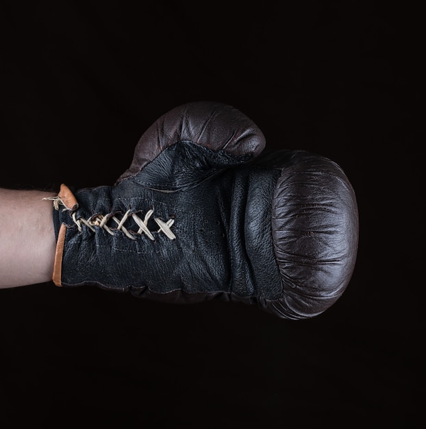 Brown boxing glove dressed on man's hand