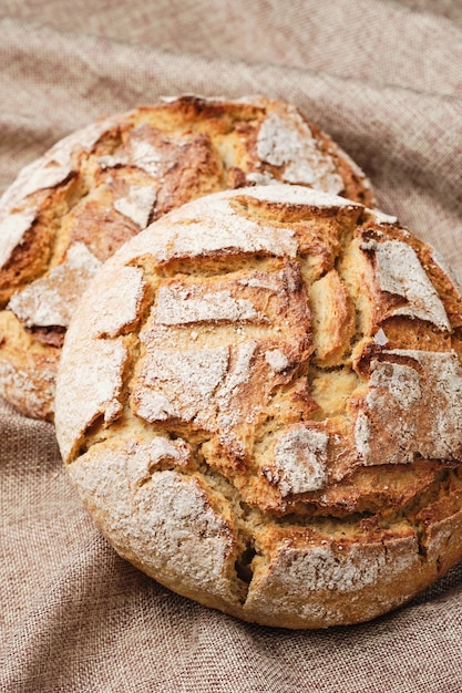 Brown bread rustic linen background top down view