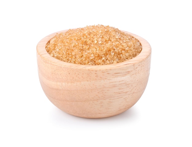 Brown cane sugar in wooden bowl on white background