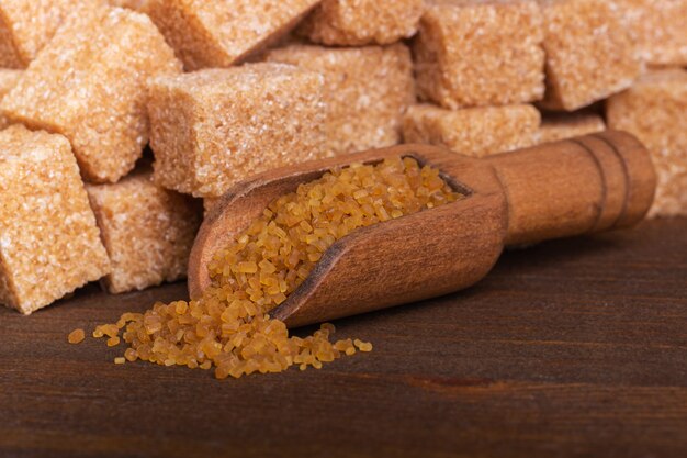 Brown cane sugar in a wooden spoon macro