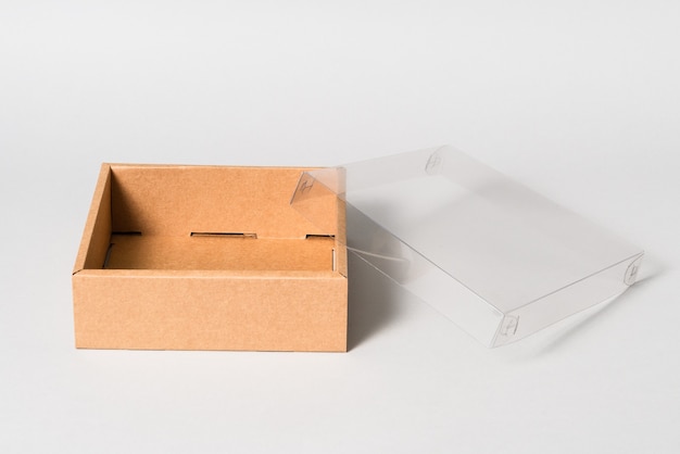 Brown cardboard carton box with transparent cover, isolated