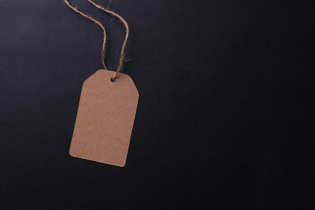 brown cardboard label with slim genuine leather cordisolated