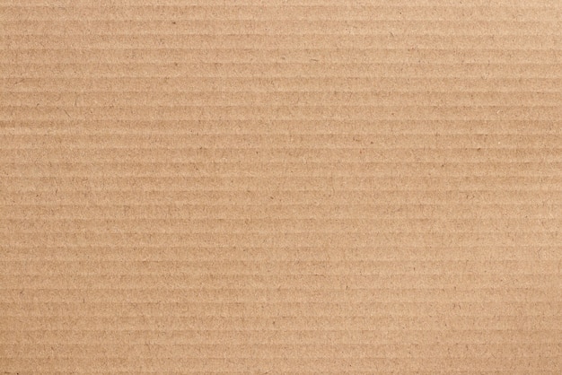 Фото Коричневый картонный лист, текстура переработанной бумажной коробки.