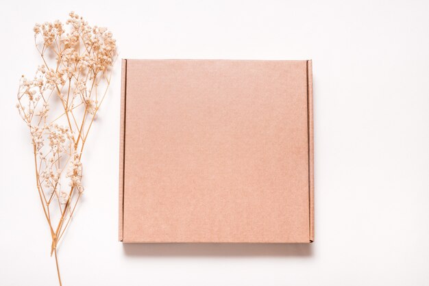 Brown Carton box decorated with dried grass