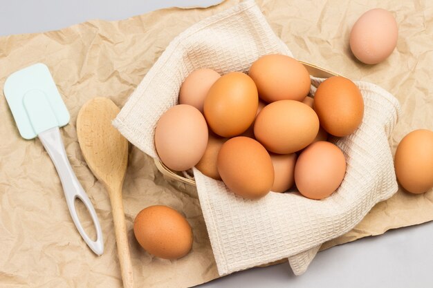 Brown chicken eggs on beige napkin. Flat lay