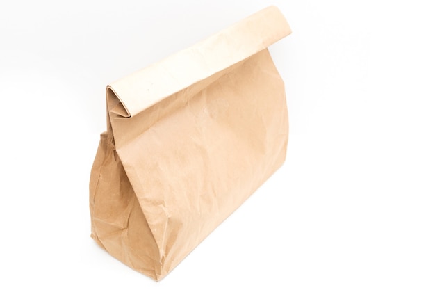 Photo brown clear empty blank craft paper bag for takeaway isolated on white background. packaging template mock up. delivery service concept. copy space.