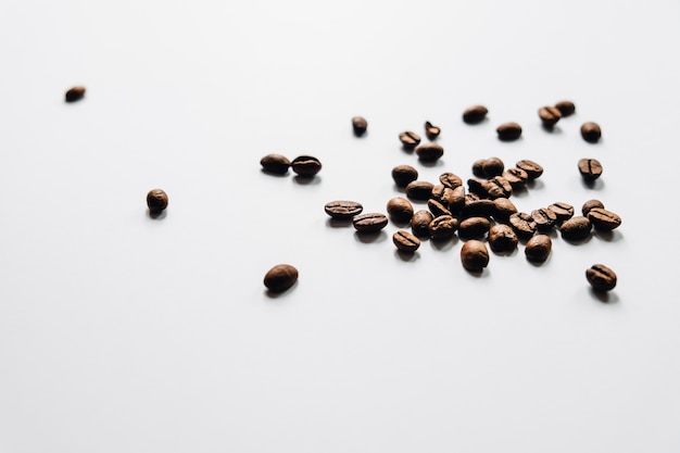 Brown coffee beans scattered on the table