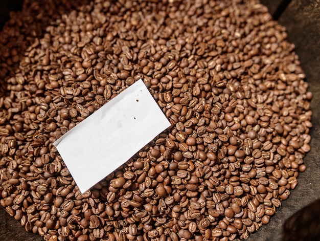 Brown coffee beans with piece of paper