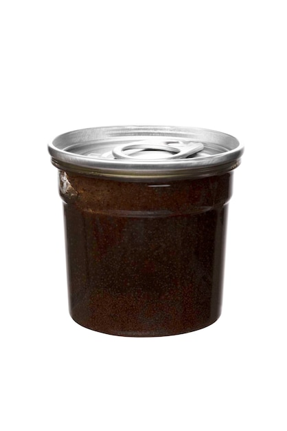 Brown coffee scrub in transparent jar with metal lid on white insulated background