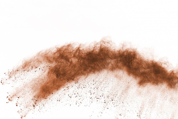 Brown color powder explosion on white background. Colored cloud. Colorful dust explode. 