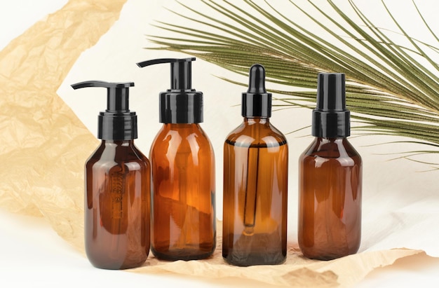 Brown cosmetic bottles on a colored background Presentation of cosmetic products