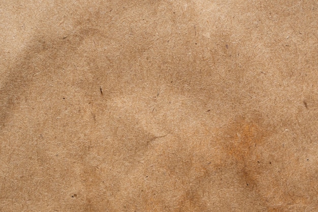 Brown crumpled paper recycled kraft sheet texture background