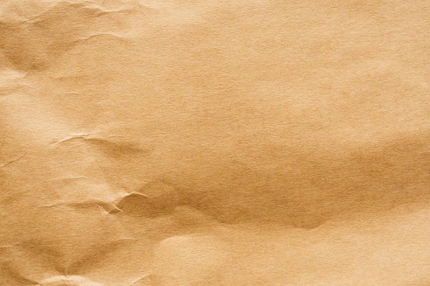 Brown crumpled paper recycled kraft sheet texture background