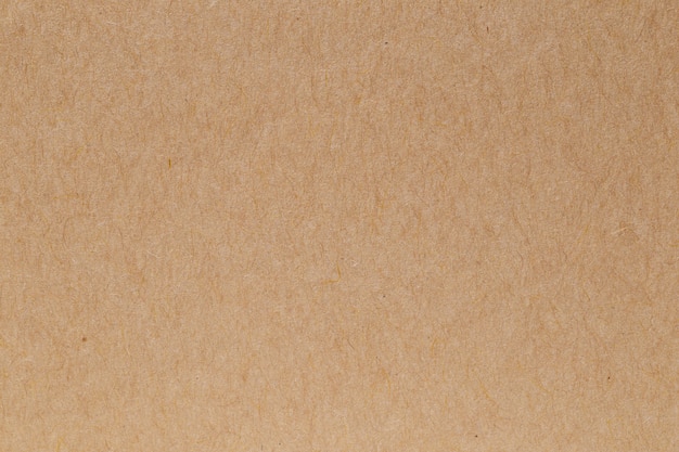 Коричневый эко переработанный фон картона текстуры листа бумаги крафт.