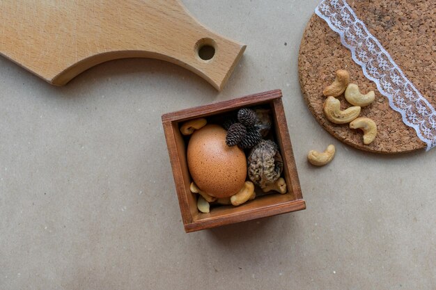 Brown egg on wood and craft paper background