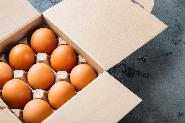 Brown eggs in carton box tray set, on gray background , with space for text copyspace