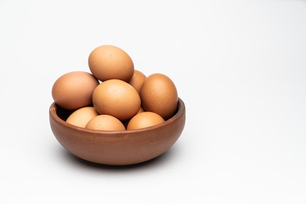 Brown eggs on a clay dish